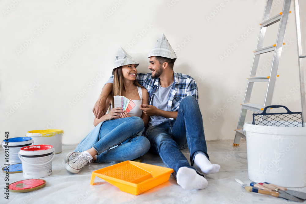 Wall mural couple doing home renovations