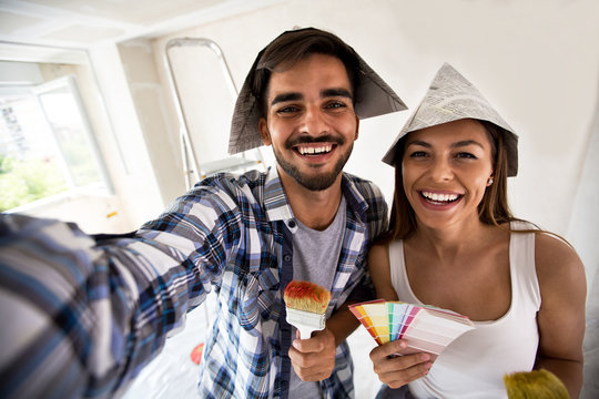 Couple Doing Selfie While Painting Their Home