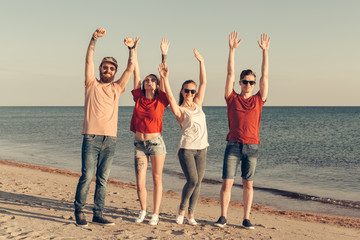 Obraz premium Group of young people enjoy summer party at the beach