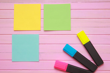 Top view of blank notebook page on pastel colored background office desk with different objects. Minimal flat lay style