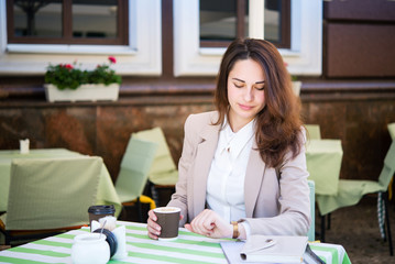 business girl is waiting for someone during a business lunch