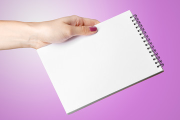 Woman Hand Holding Blank Spiral Notepad.