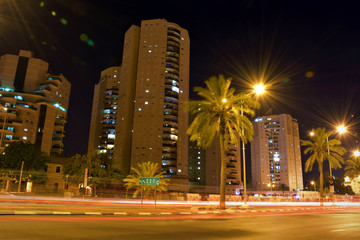 Fototapeta na wymiar Nice city street with tall buildings at night in Israel Beer sheva