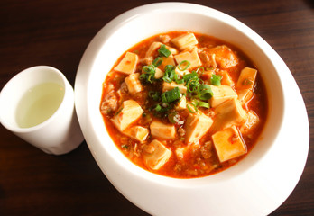 Closeup Chinese Food,Mapo doufu Chinese in white dish with tea cup