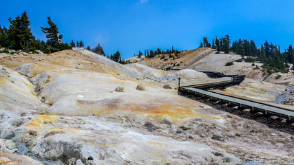 Boardwalk at Bumpass Hell, Lassen Volcanic National Park, USA. This is the largest hydrothermal area in the park, and the main area of upflow of steam from Lassen hydrothermal system