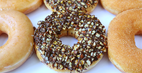 Chocolate with Chopped Almond Donuts with Sugar-glazed and Cinnamon-sugar Donuts on White Background 