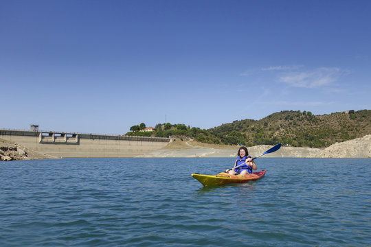 Young woman rowing in a kayak