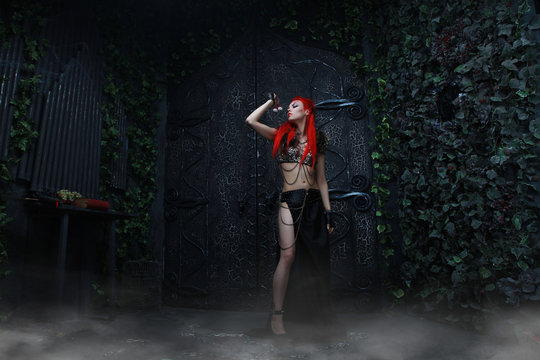 beautiful redhead woman warrior near the dark gothic huge gates