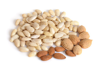 Blanched almonds  with unshelled nuts. On white background.