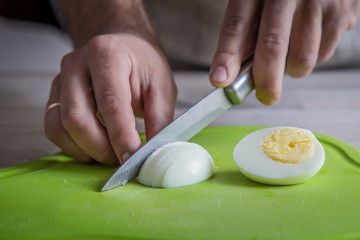 cutting eggs on green cutting board