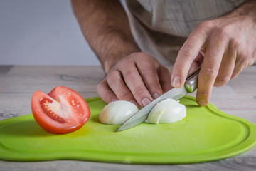 cutting eggs on green cutting board
