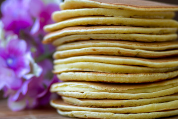 Obraz premium Tasty homemade pancakes with cream and raspberry. On wooden table. Village kitchen