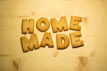 Home Made text made with cookies on a wood table