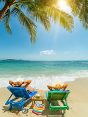 Fototapeta na wymiar Couple on the beach at tropical resort Travel