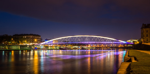 Bernatka footbridge over Vistula river at night in Cracow, Poland