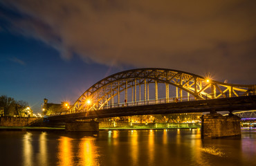 Bridge over Vistula river at night in Cracow, Poland