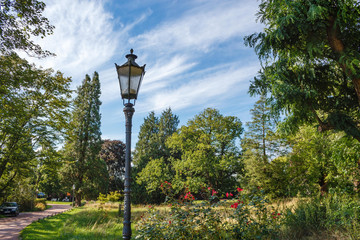 Old street lantern in the park at sunshine and blue sky