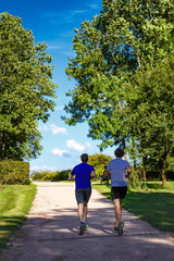 Two young men running in the park