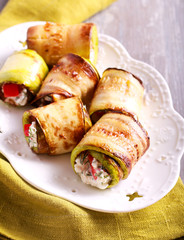 Zucchini rolls with cheese, dill and tomato filling