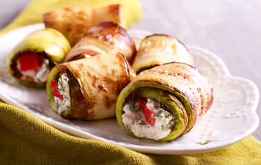 Zucchini rolls with cheese, dill and tomato filling