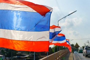 close up thai flags on the pole blown by wind in sunny and cloudy day.
