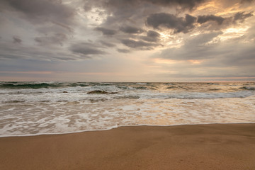 Majestic ocean sunset with a breaking wave