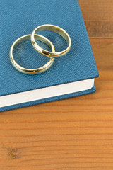 Gold wedding rings on blue bible book