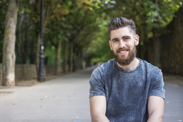 Portrait of a caucasian man with a beard, smiling.