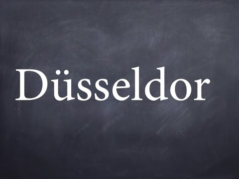 Wort D&uuml;sseldorf geschrieben auf Schiefertafel mit Kreide &ndash; Animation