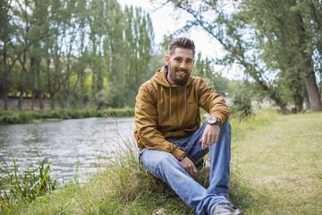 Man sitting on the bank of the river.