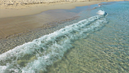 The waves cover a sandy coast