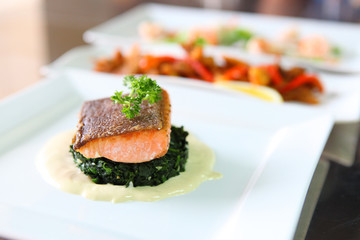 Grilled salmon steak on white plate