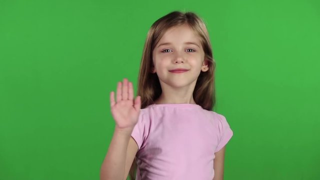 Baby is waving to others. Green screen. Slow motion