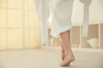 Young woman walking on floor after shower