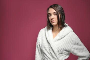 Fototapeta premium Young woman with wet hair in white terrycloth robe, skincare and self-care routine, beauty and wellness