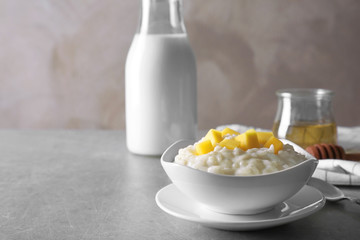 Delicious breakfast with rice pudding and fruit on kitchen table