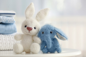 Cute knitted toys on table