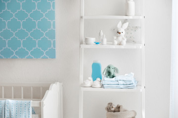 Beautiful light room with toys and baby accessories on shelves
