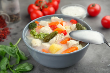 Bowl with delicious turkey soup on table