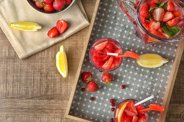 Composition with delicious strawberry lemonade on table