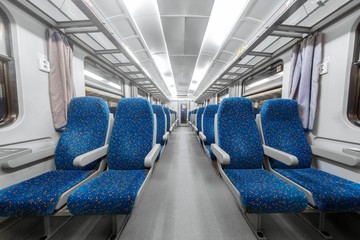 Empty train interior with blue chairs