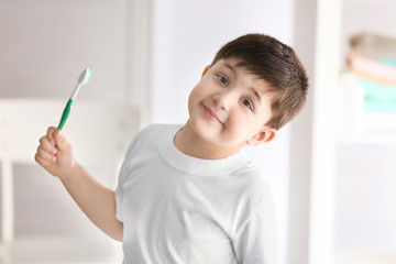 Cute little boy with toothbrush at home. Cleaning teeth concept