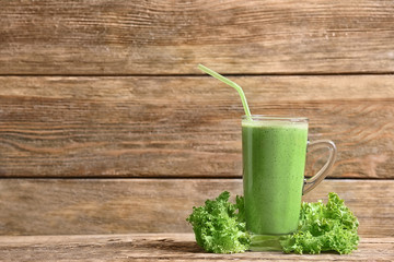 Glass of fresh vegetable smoothie on wooden background