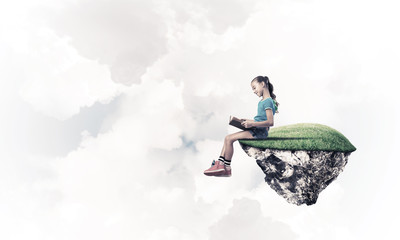 Concept of careless happy childhood with girl reading book