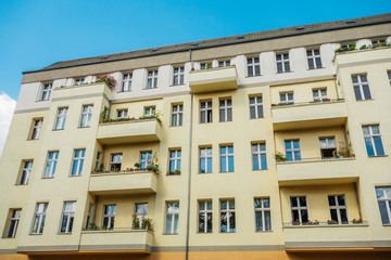 yellow building with white roof and blue sky