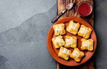 Mini chilean empanadas on clay plate with typical chilean drink vino con harina - red wine with toasted flour