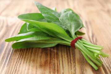 Fresh spinach bunch on wooden background