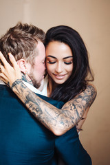 Beautiful, young couple posing on camera indoors