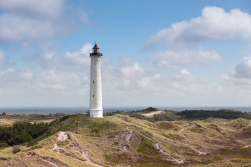 Fototapeta na wymiar Lighthouse of Norre Lyngvig at the Danish coast of the northern sea