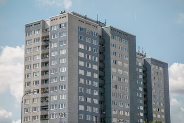 Fototapeta na wymiar old plattenbau skyscraper with grey facade